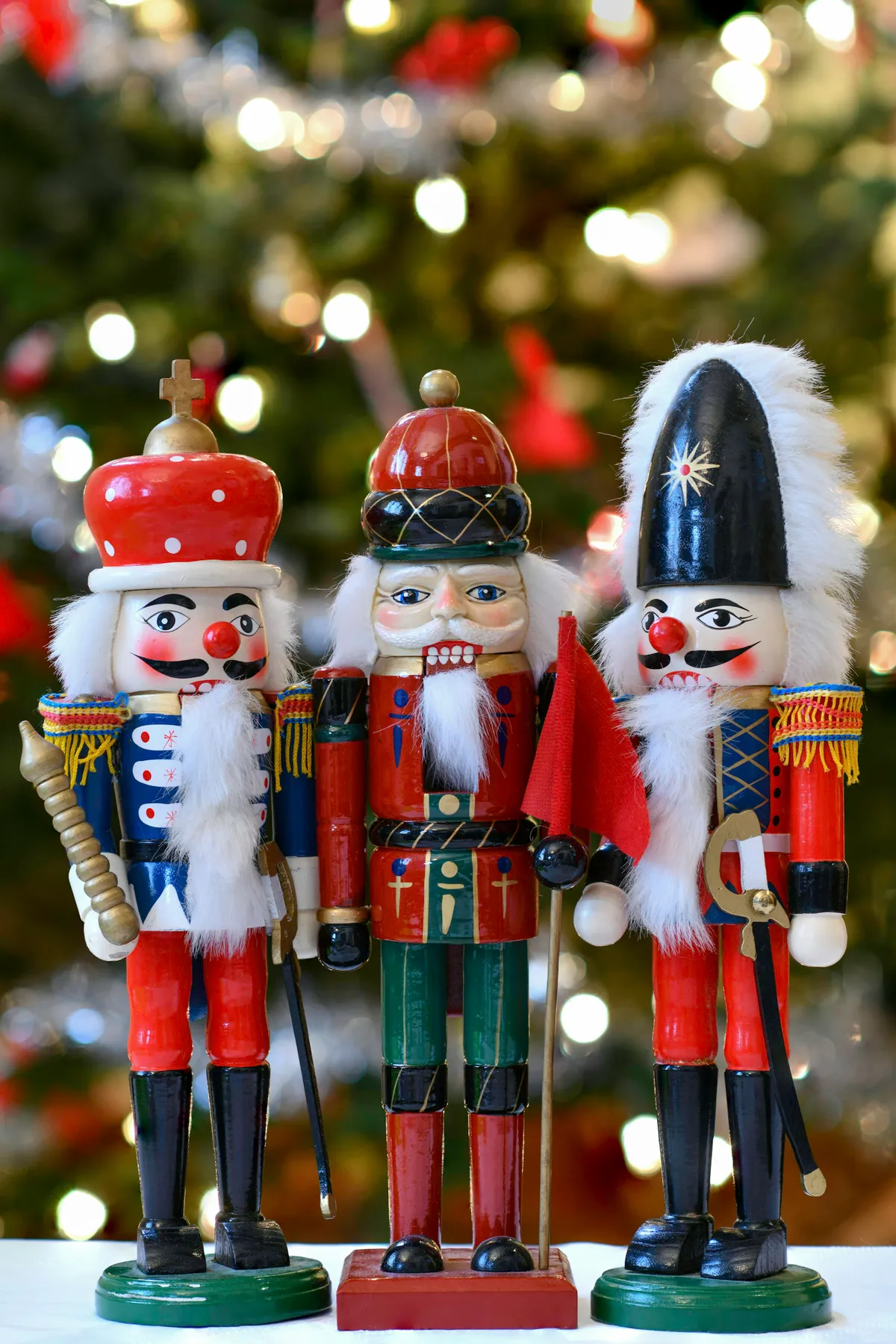 A group of nutcrackers standing next to a christmas tree - Free Photo on  Unsplash