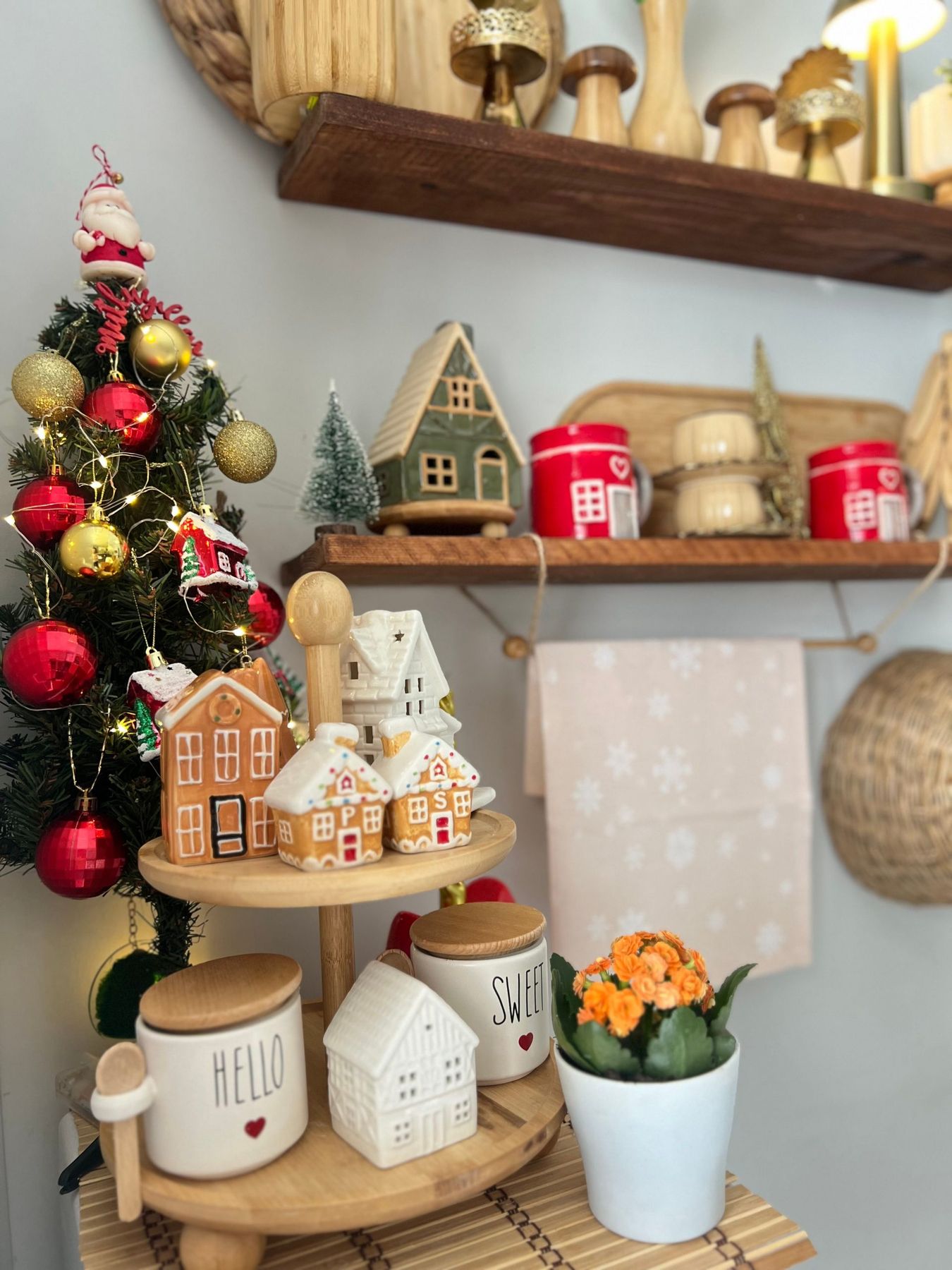 Charming kitchen corner with festive decor, gingerbread houses, and a mini Christmas tree.