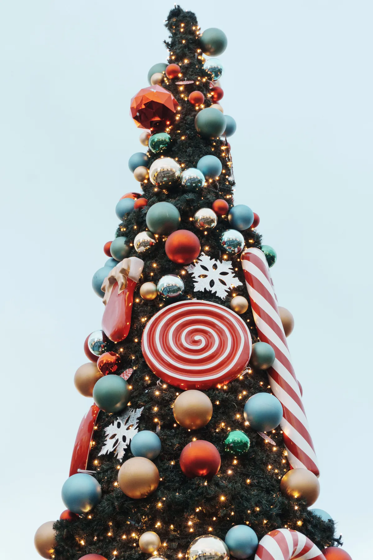 Colorful Christmas tree in Istanbul adorned with candy-themed decorations and lights.