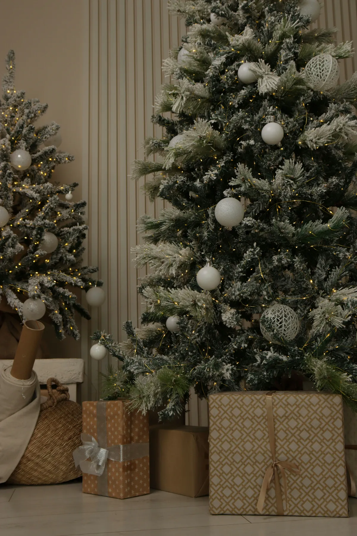 Two decorated christmas trees with gifts underneath