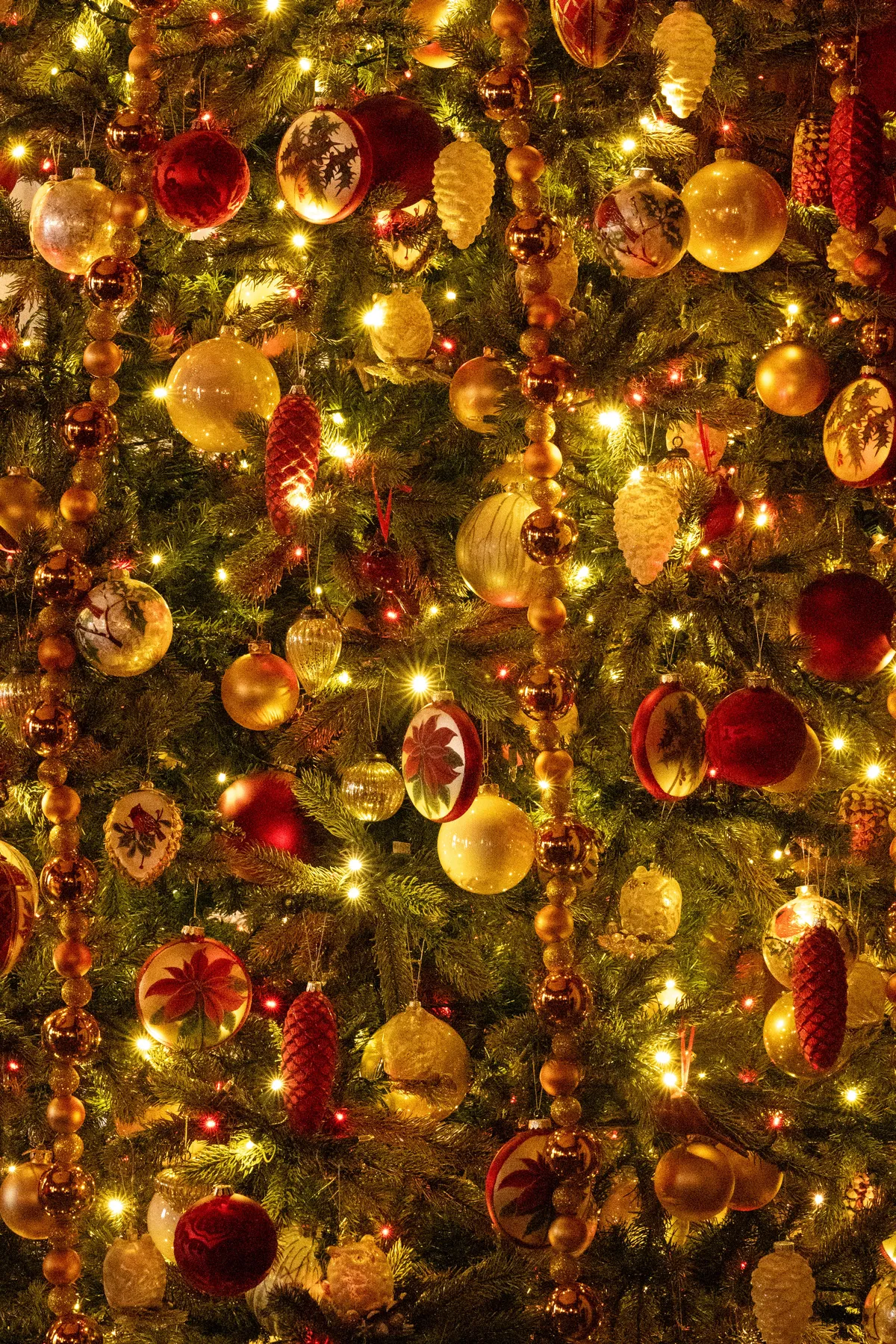 Vibrant decorated Christmas tree with ornaments and glowing lights, capturing the festive holiday spirit.