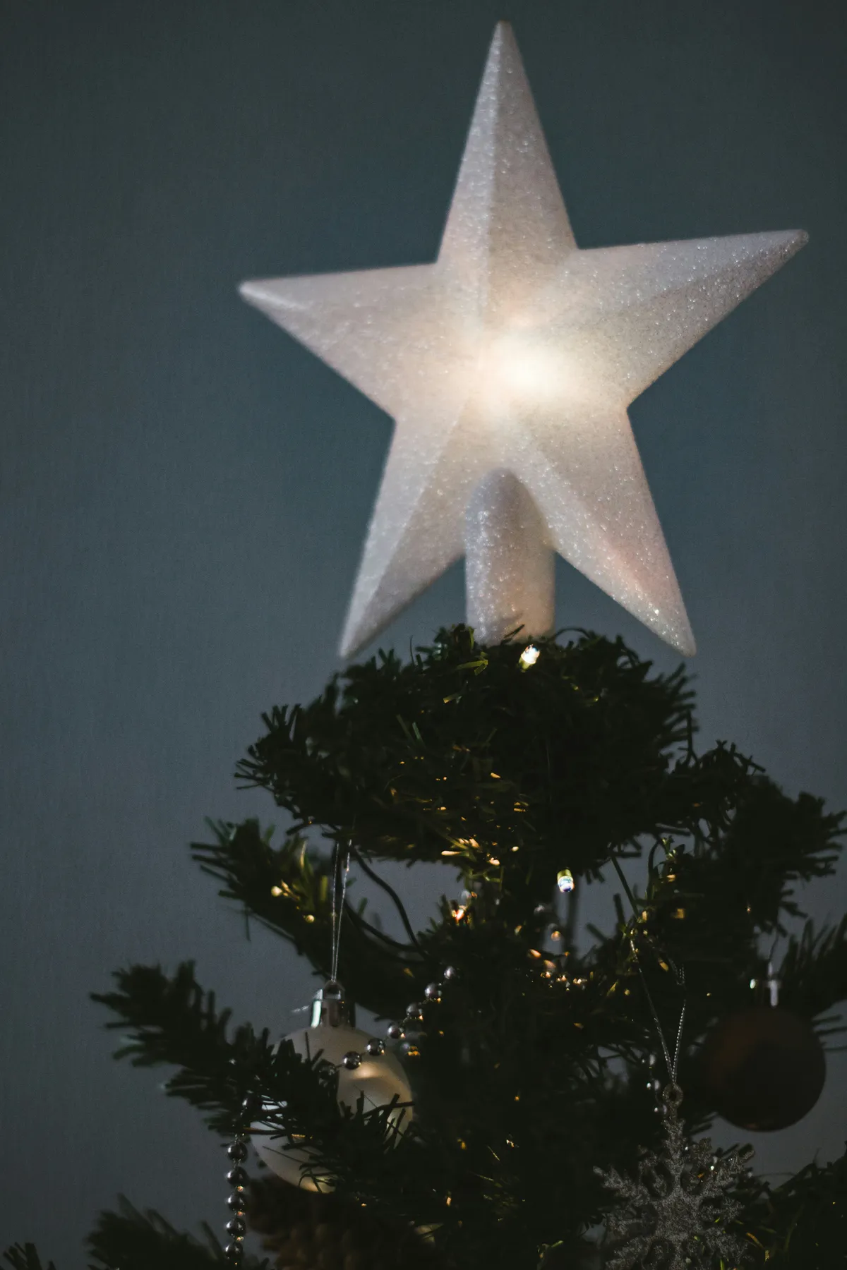 white star ornament on green christmas tree